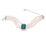 Artificial pearl jewellery set – choker, bracelet, and earrings with emerald green stones