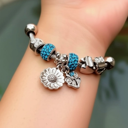 Stylish Blue Crystal Silver Charm Bracelet with Blue Beads & Daisy Pendant on Wrist