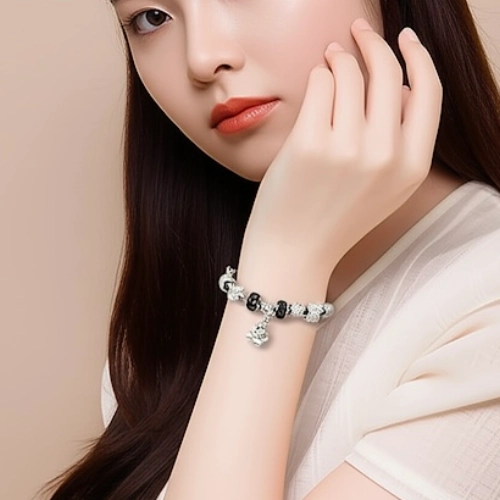 Teddy Bear Charm Silver Bracelet worn on wrist by woman