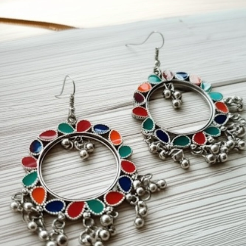 Side view of colorful oxidized hoop earrings with multicolor enamel and dangling beads