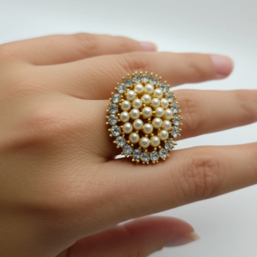 Angled view of pearl and crystal statement ring with layered cluster design
