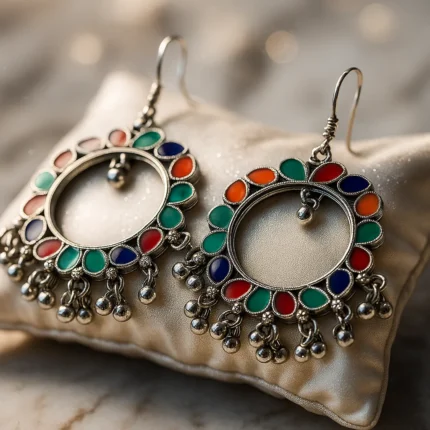 Pair of colorful oxidized hoop earrings with multicolor enamel and beaded danglers on white background