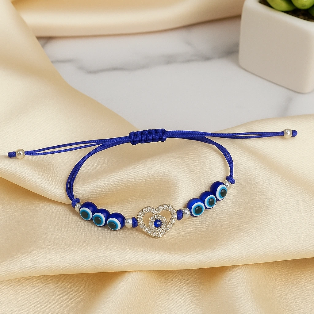 Stylish blue evil eye bracelet with heart charm displayed on wooden surface for fashion styling.