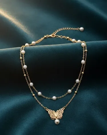 Dainty butterfly anklet with pearls on marble surface - minimalist ankle jewelry