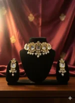 Traditional Indian Kundan choker necklace set with matching earrings displayed on black velvet jewelry stand against navy blue silk backdrop