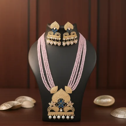 Bridal Kundan necklace with pearl beaded multi-layer design and gold earrings worn by a woman.