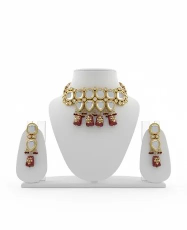 Indian woman wearing gold kundan choker necklace with red stones and matching earrings with maroon ethnic outfit